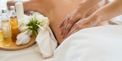 woman getting a massage with aromatherapy
