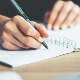 person writing in notebook