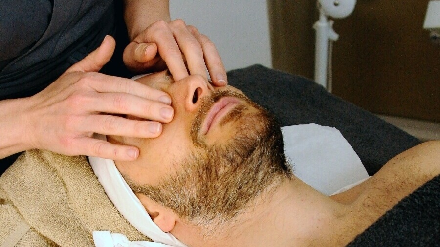 esthetician massaging client's face