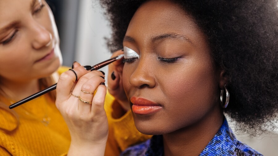 makeup artist applying makeup to client's face