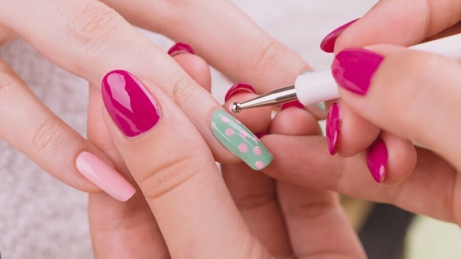 nail tech painting client's nails