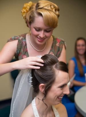 Destinee styling a bride's hair