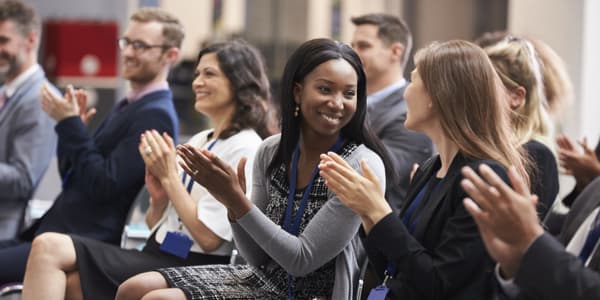 group of professionals smiling and clapping