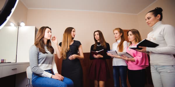 group of students taking notes at Beauty school