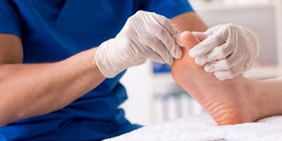 doctor inspecting a patient's foot