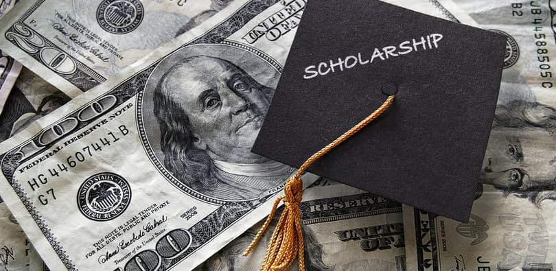 graduation hat on dollar bills