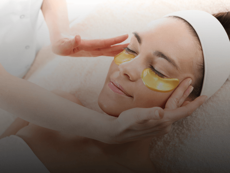 person with under eye treatment mask on