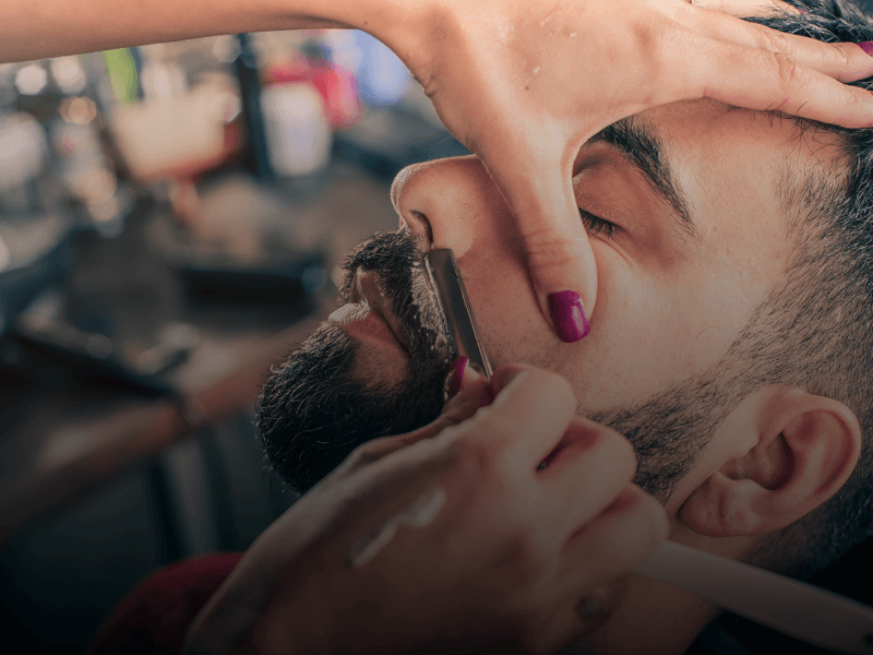 a person getting his beard shaved