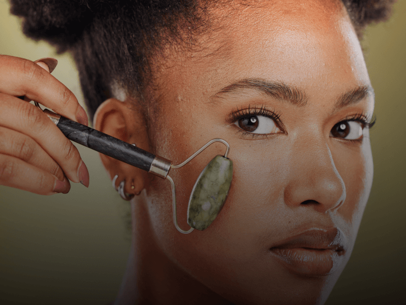 person using facial roller