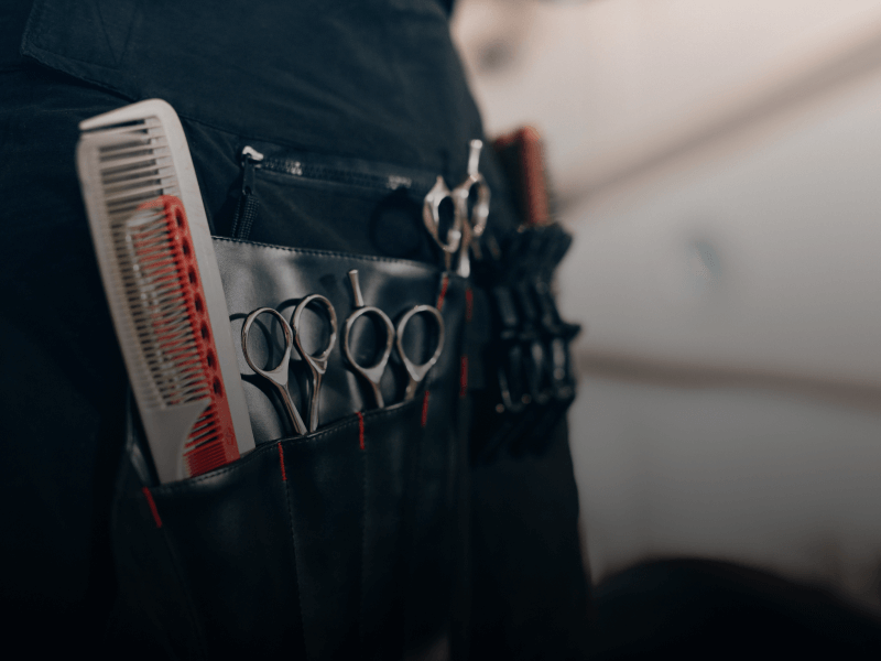 a hairdresser's tool belt with scissors and comb